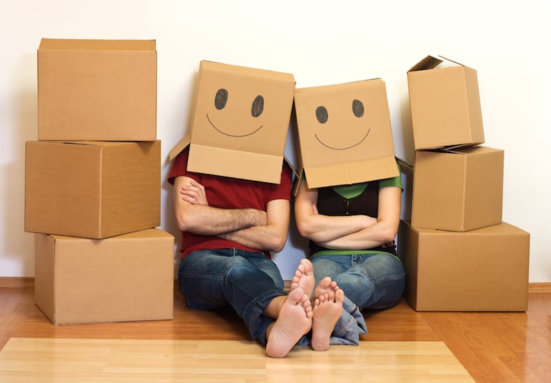 couple with smiley face moving boxes