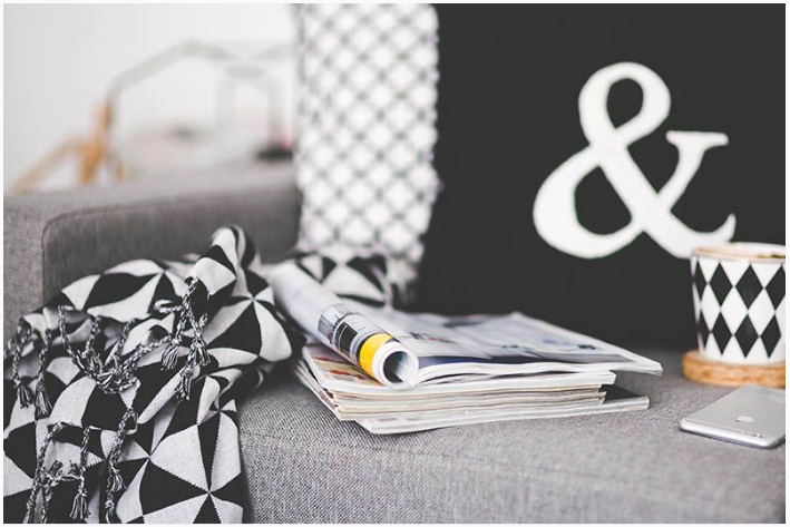magazines on a sofa, ways to get rid of clutter at home