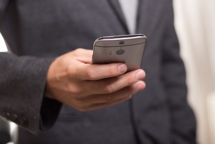 businessman holding phone