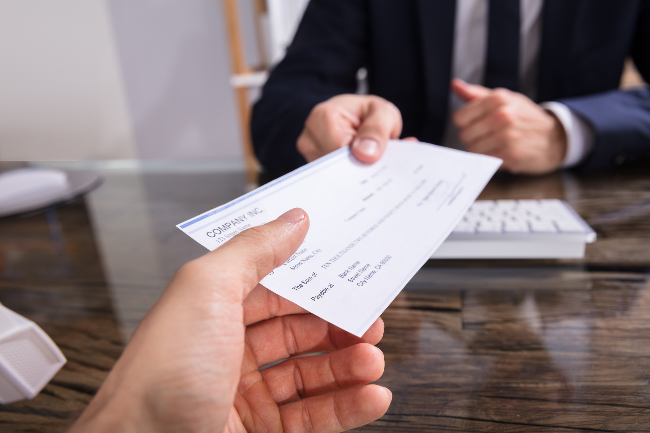 A person haning a cheque to a property agent