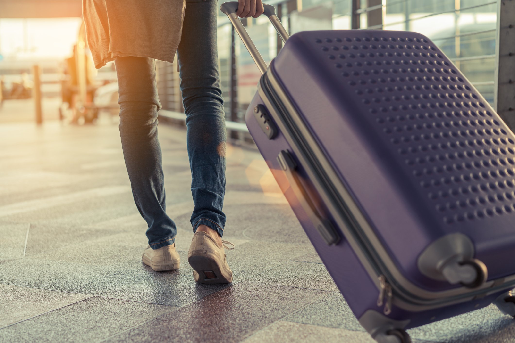 Traveller pulling luggage at the airport