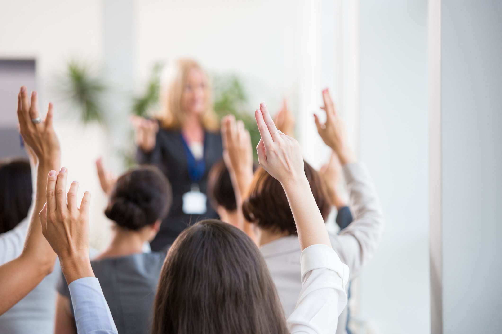 Group of people raising hands