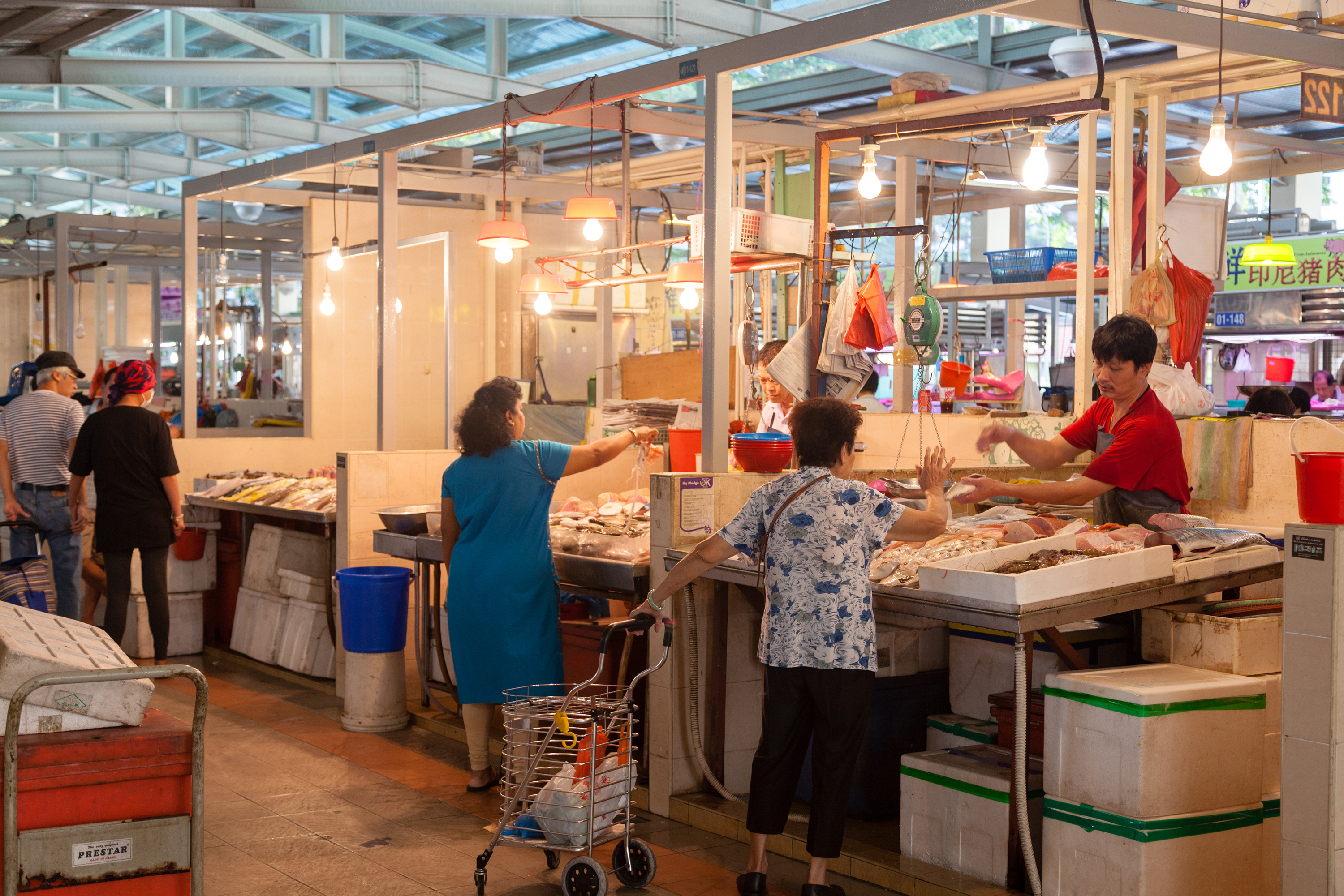 Elderly buying fresh fish in the wet market