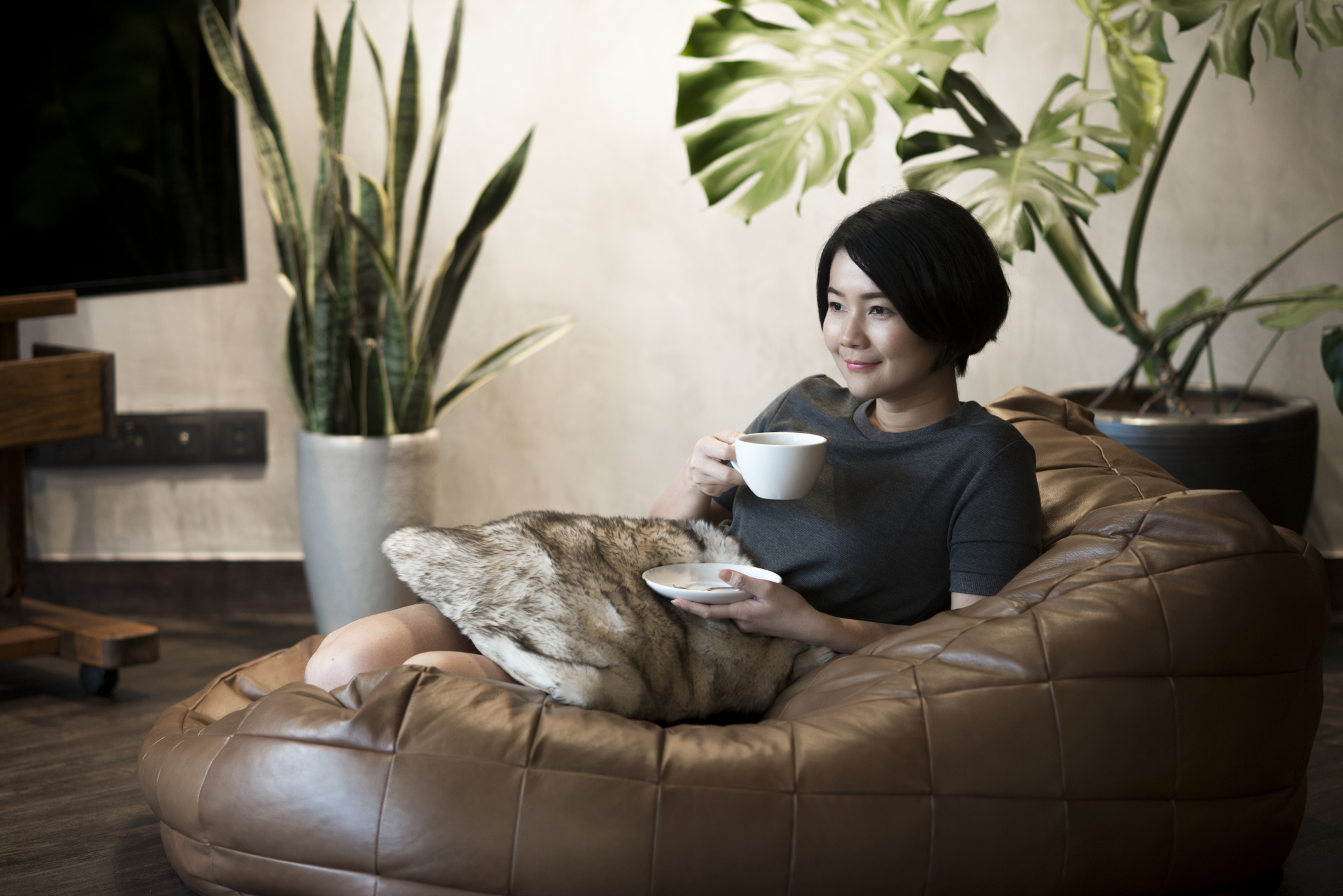 Young woman drinking herbal medicine at home