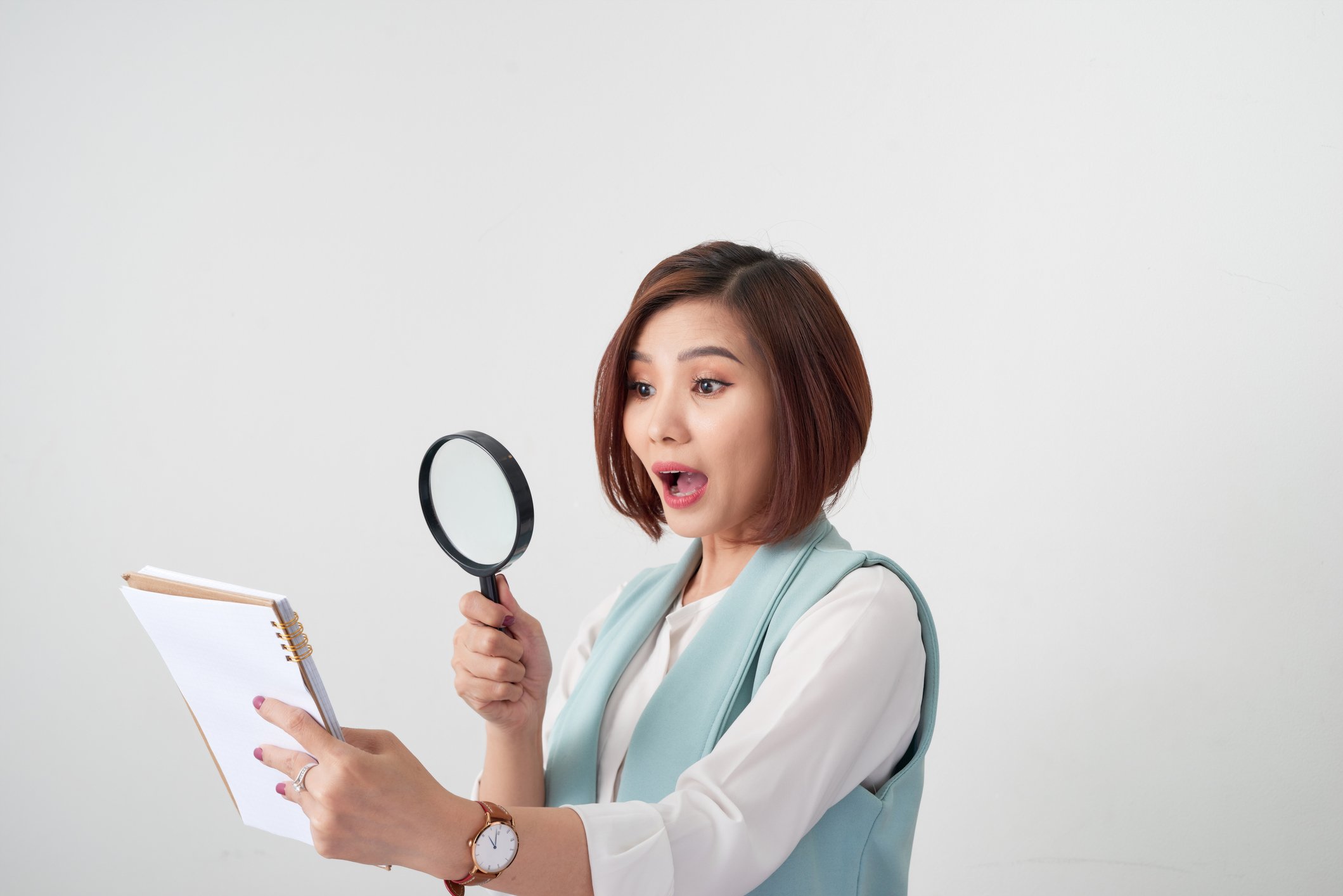 Woman with magnifying glass reading contract