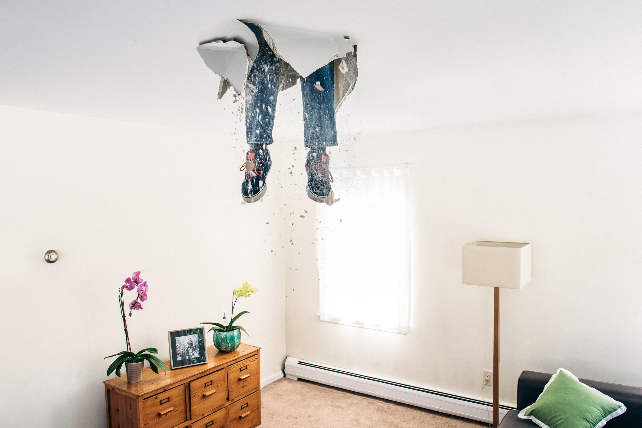 legs sticking out of a false ceiling