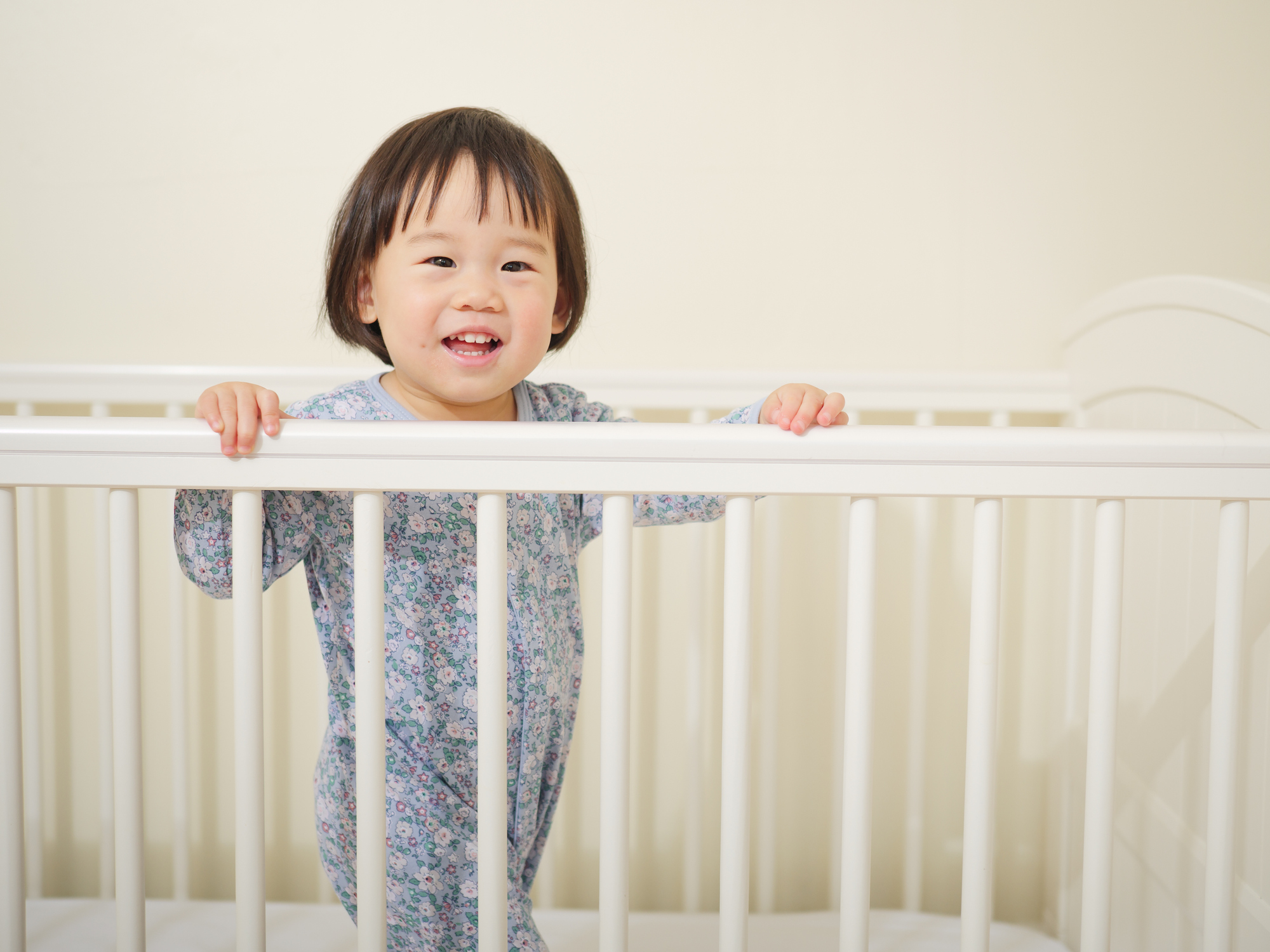 Cute asian baby girl in cot bed