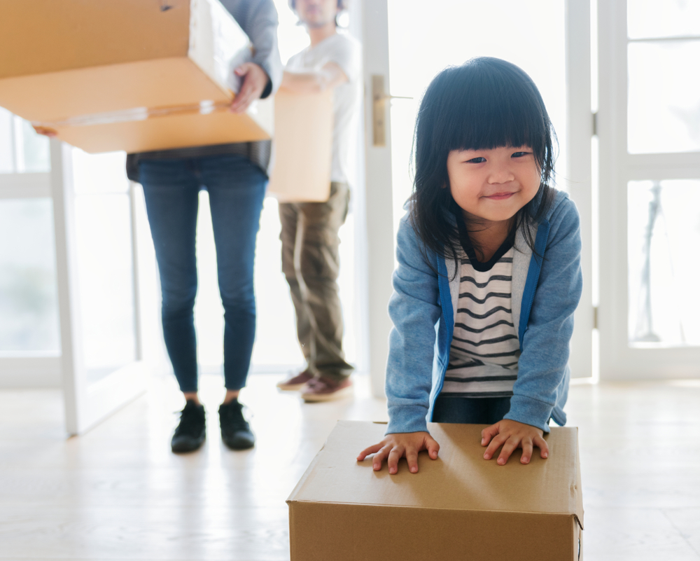 kid playing with packing box