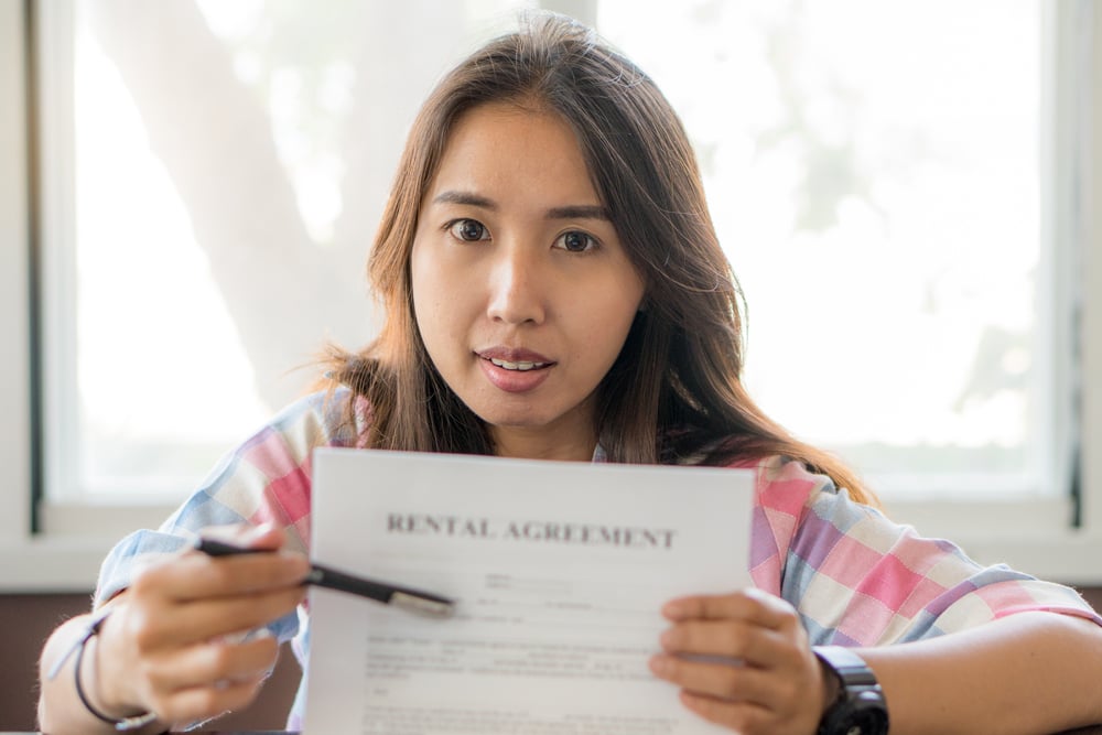 woman holding rental agreement paper