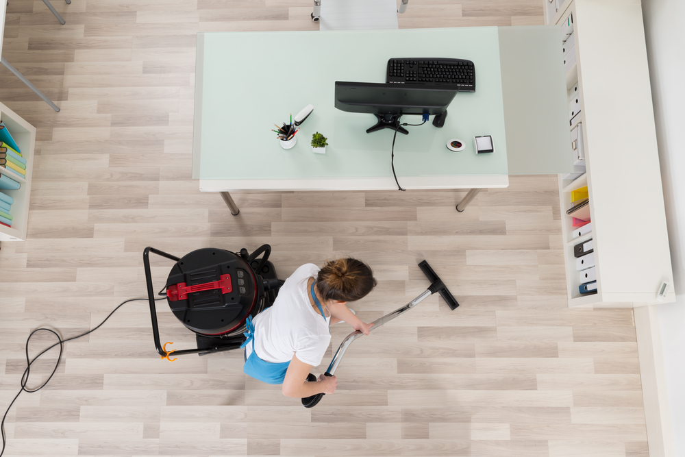 Lady vacuuming her office space