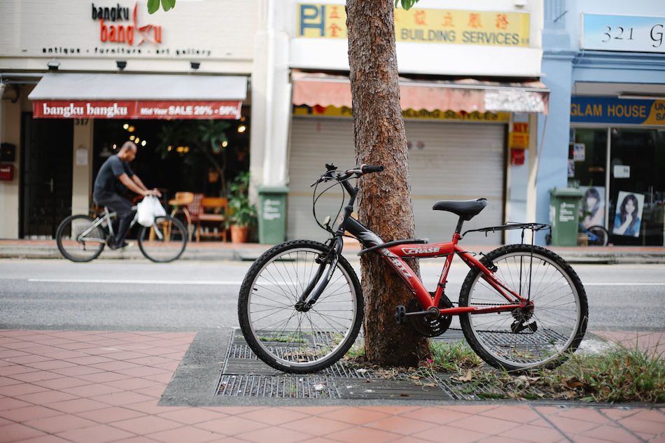 East Coast katong singapore bicycle parked and local bicycling past