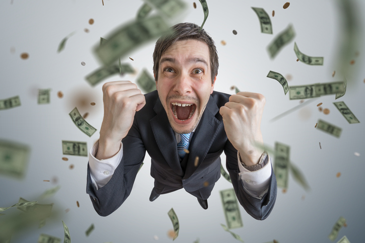 money falling onto young businessman