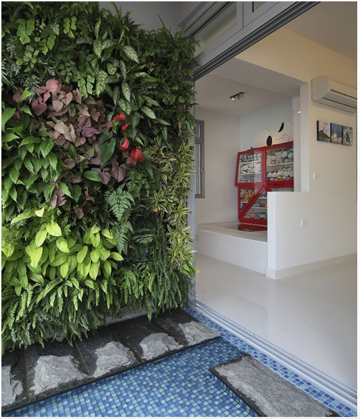 Green elements were factored in the space planning of this home. A vertical garden and water add a touch of nature in this urban enclave