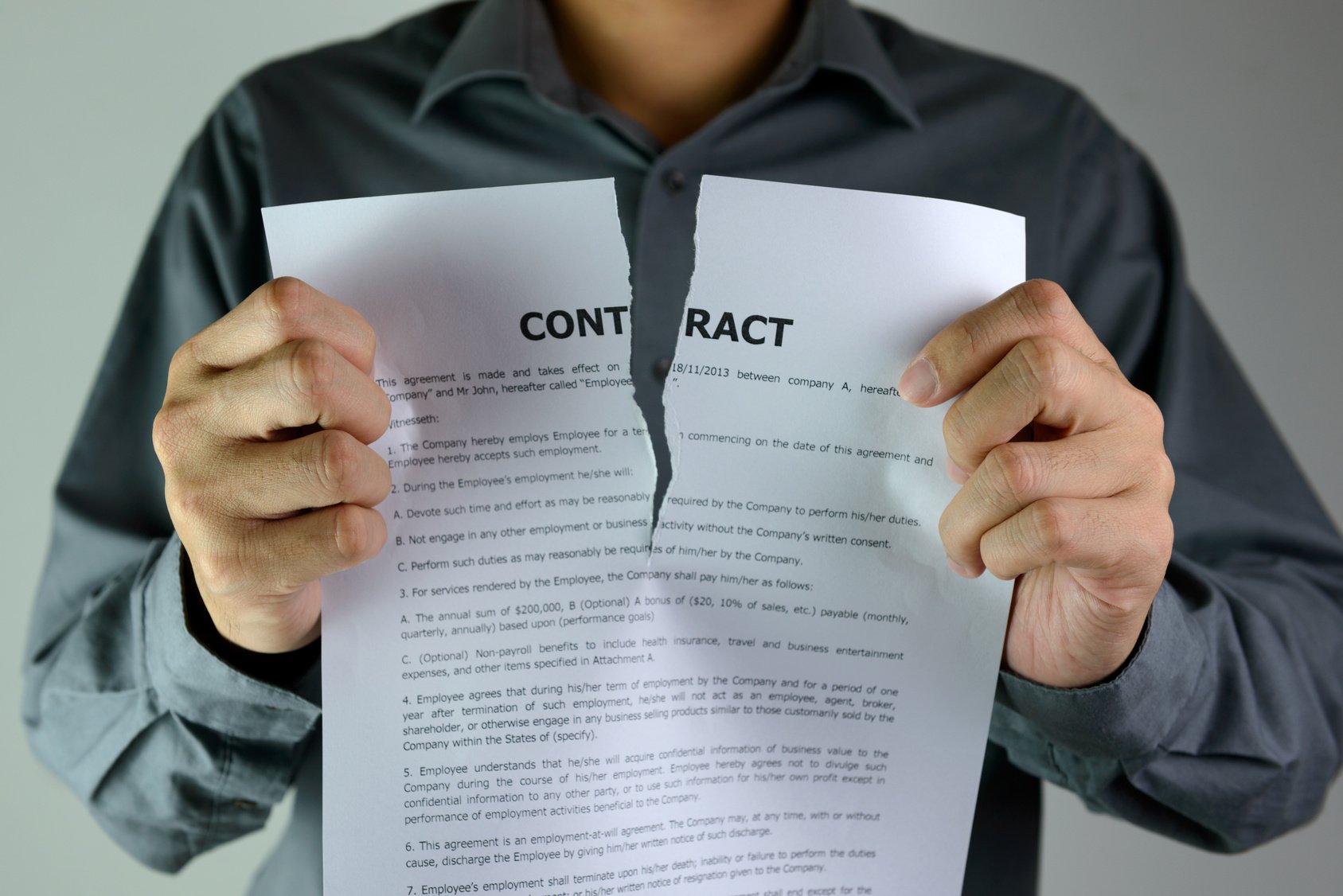 Person tearing a tenancy agreement.
