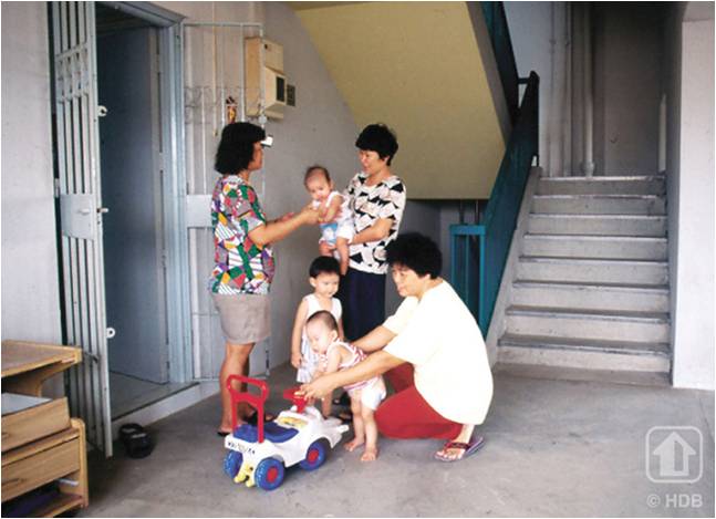 ladies interacting with their neighbours in front of an HDB flat