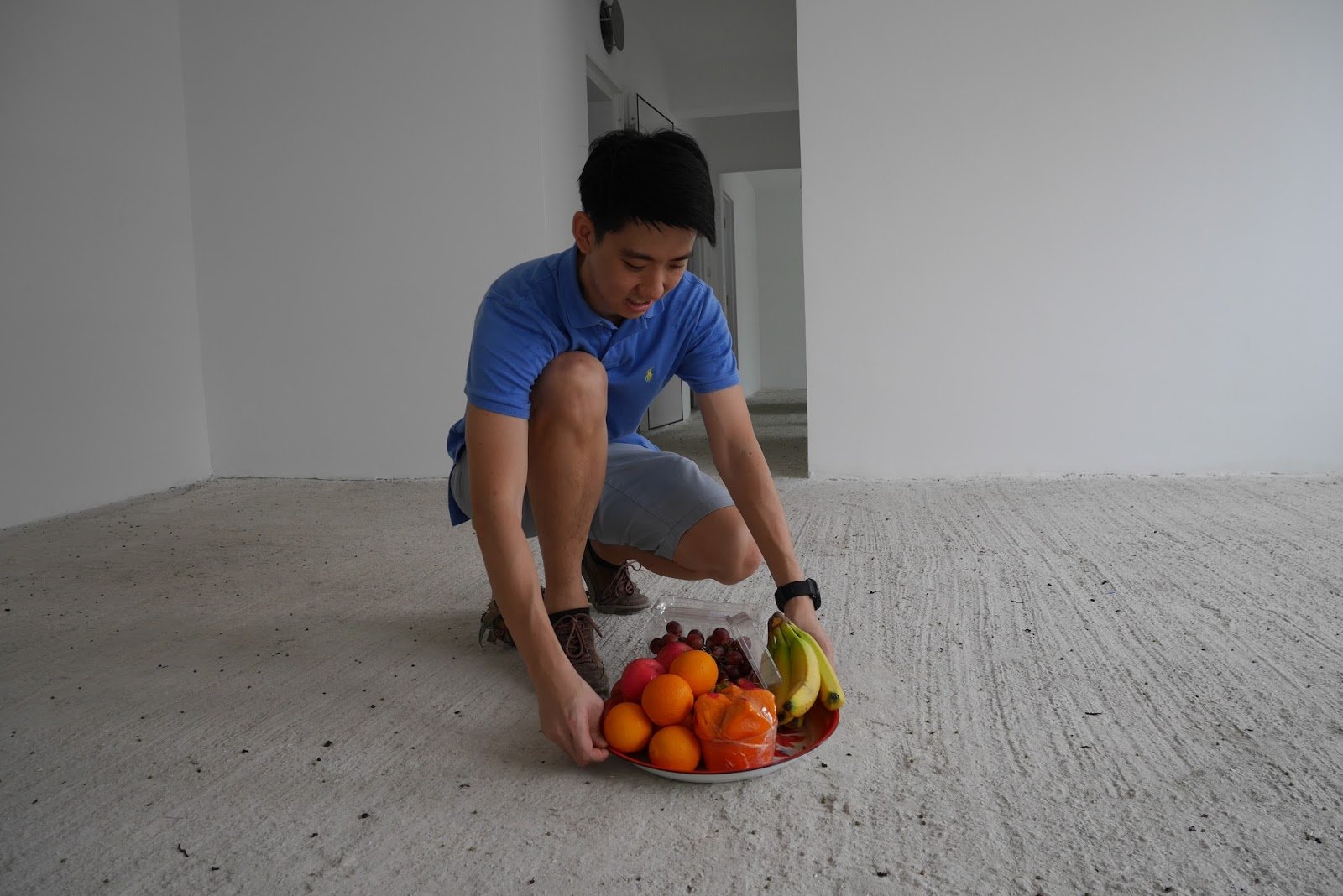 man carrying fresh fruits as part of Chinese ritual for moving in a new house