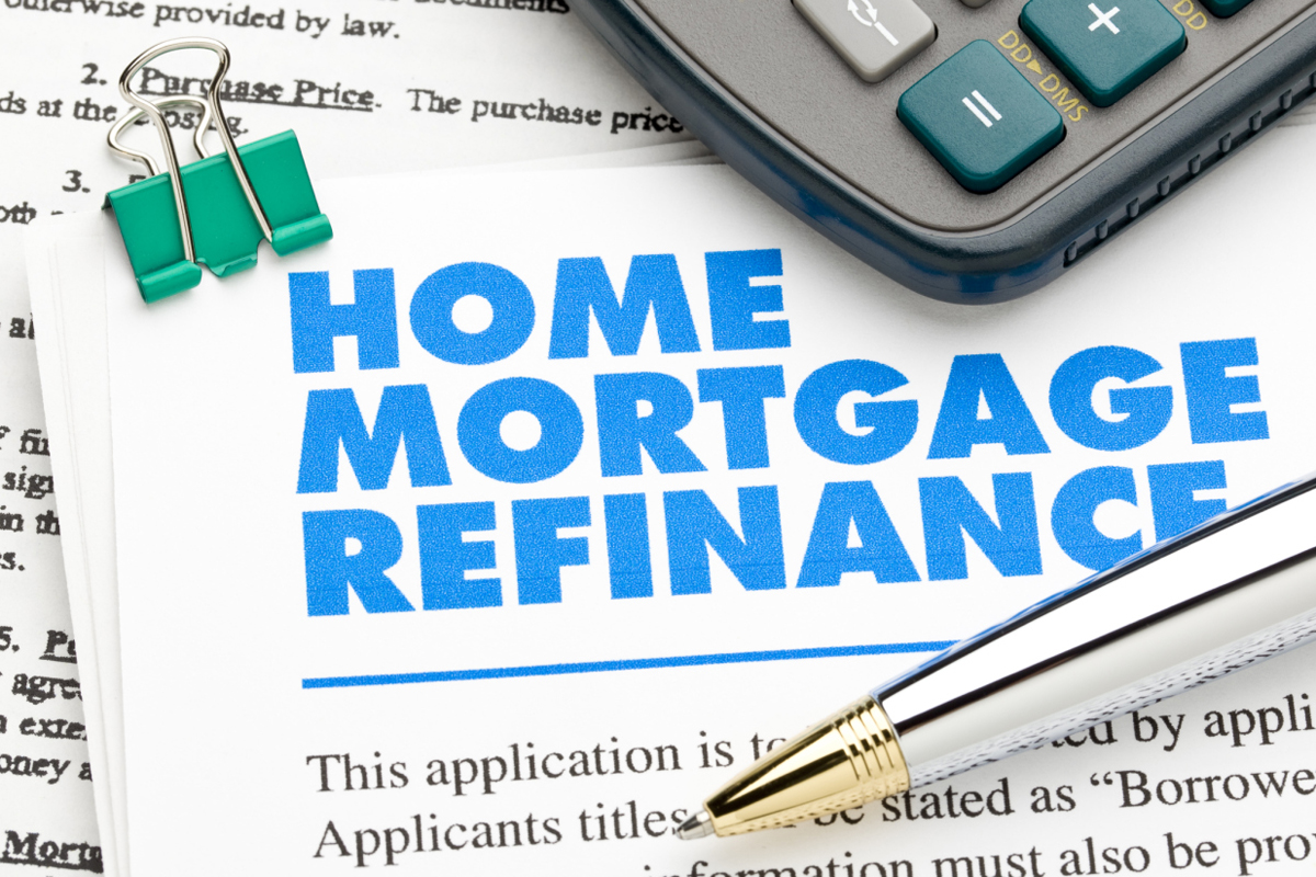 Documents relating to Home Mortgage Refinance, along with a pen and calculator