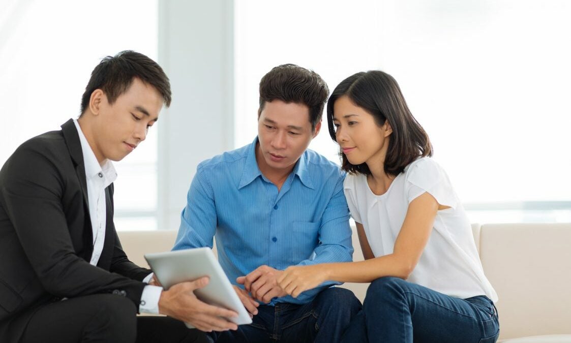 Couple talking to a real estate agent