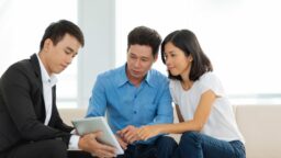 Couple talking to a real estate agent