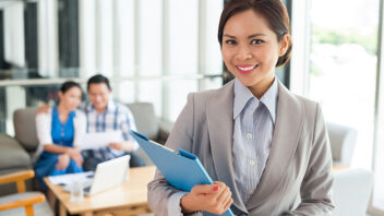 Female real estate agent holding a file