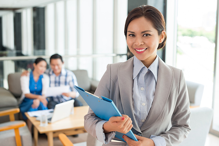 Female real estate agent holding a file