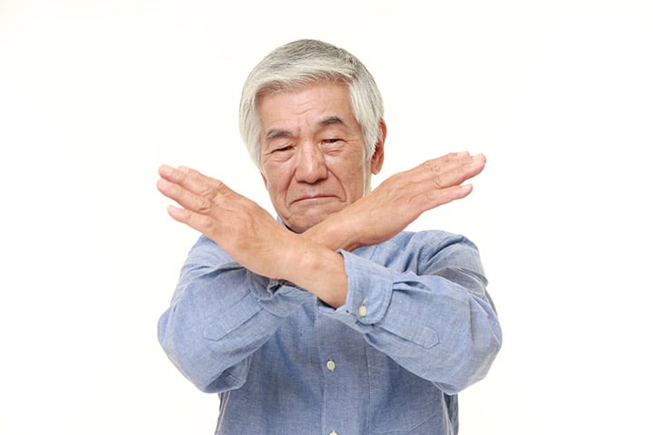 Old man crossing his arms in an X