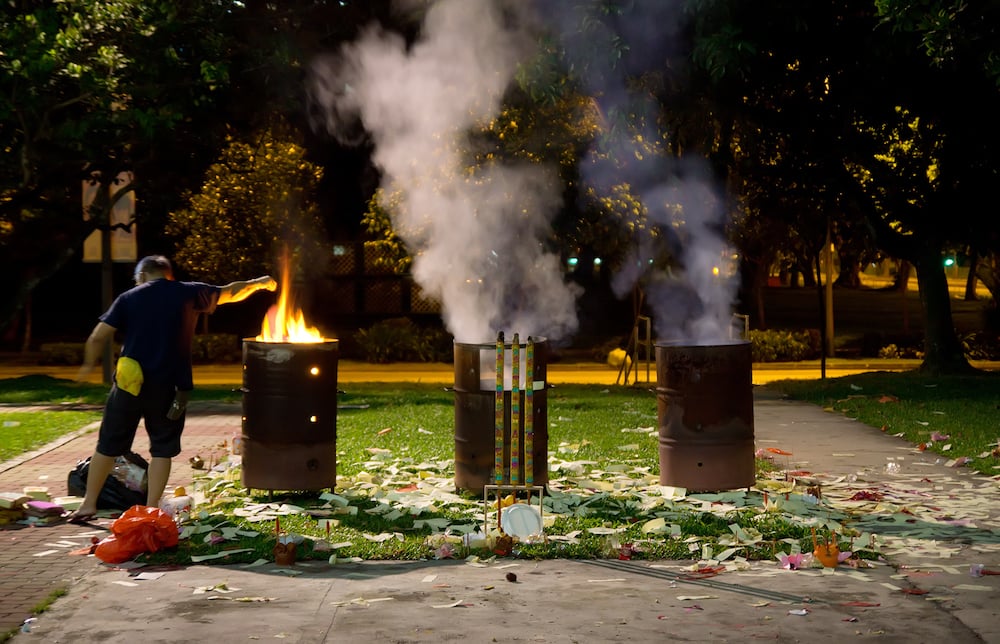 Burning money in bins for hungry ghost festival