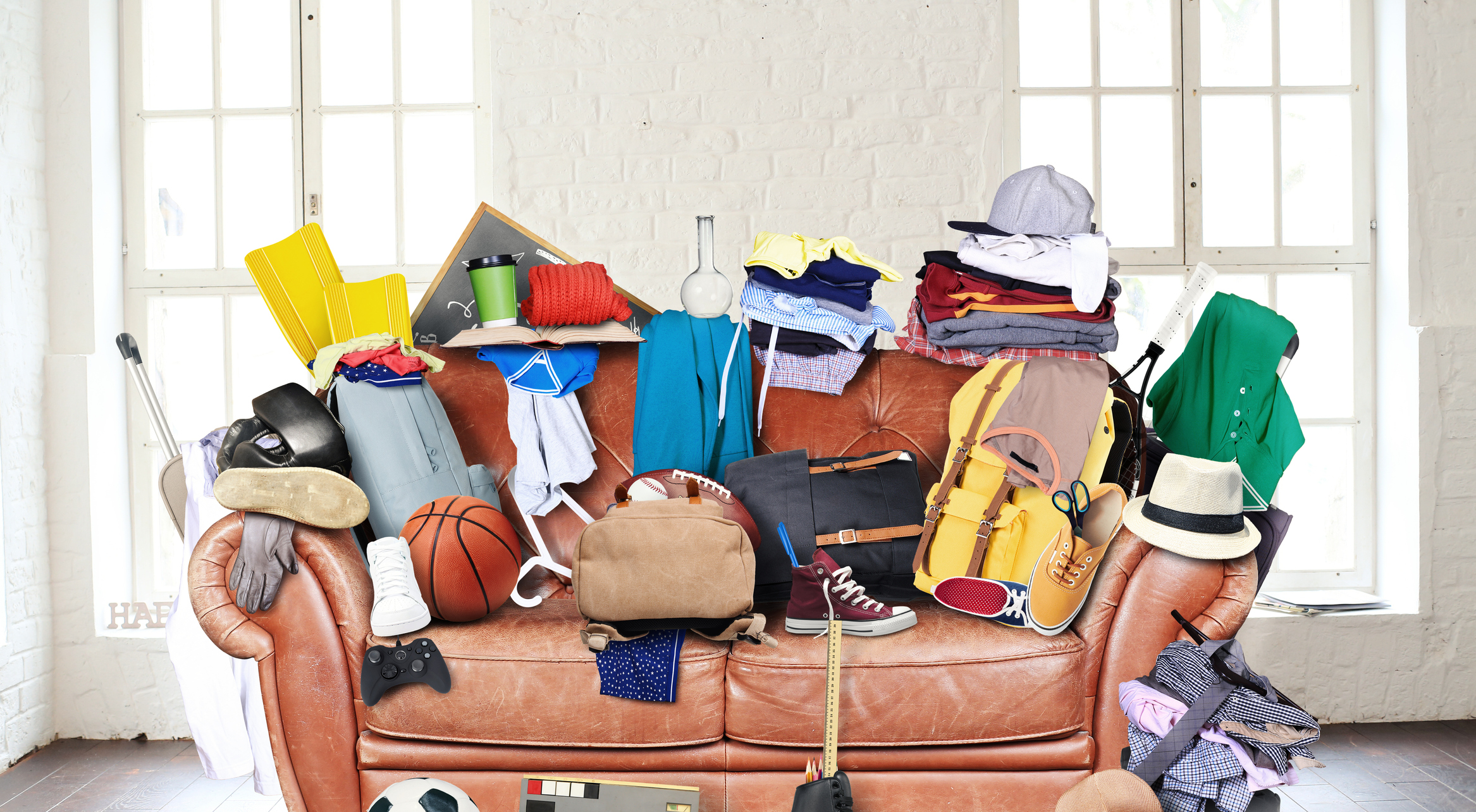 Couch cluttered with household objects