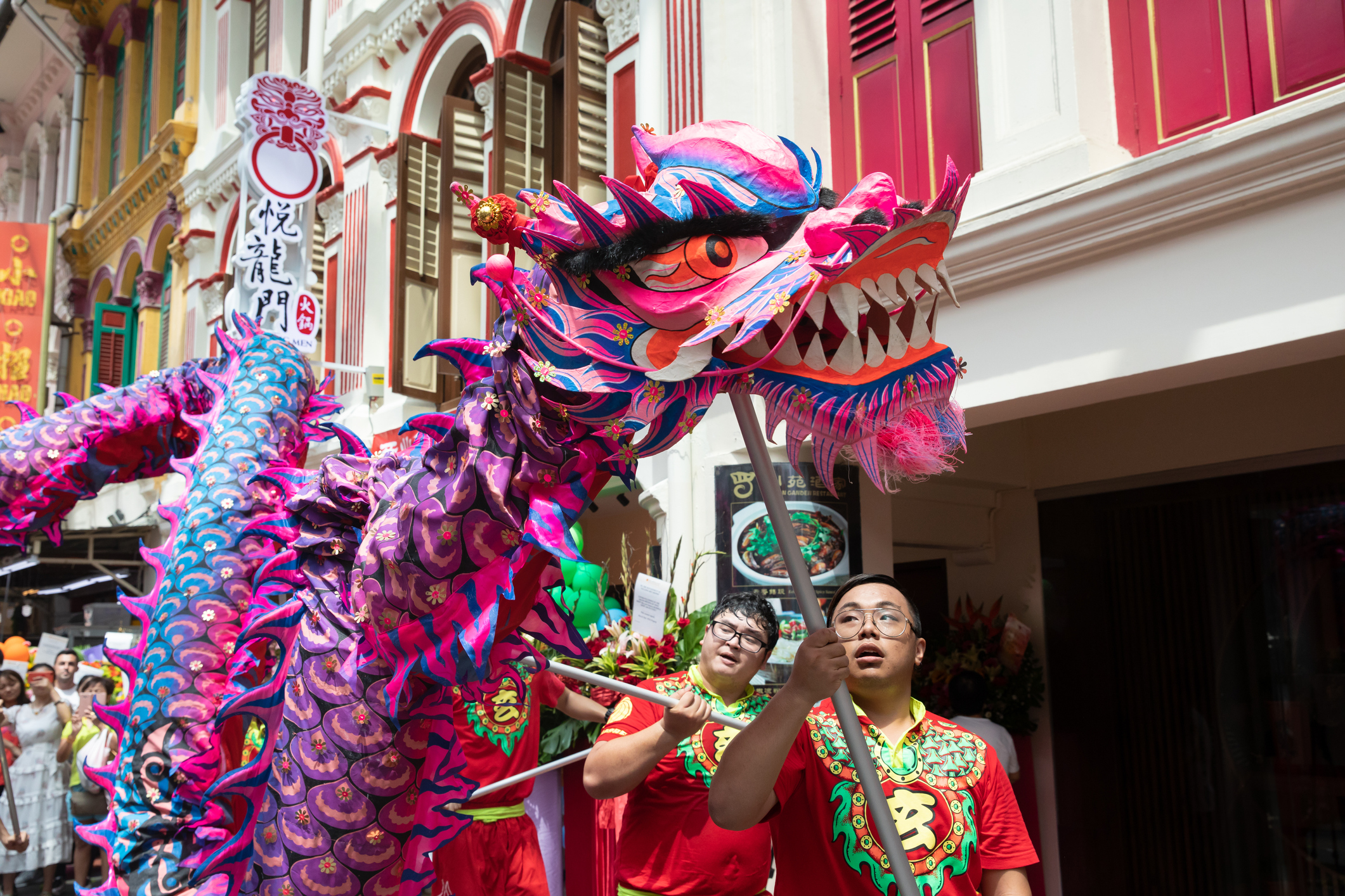 Dragon dance outside shophouse in Chinatown