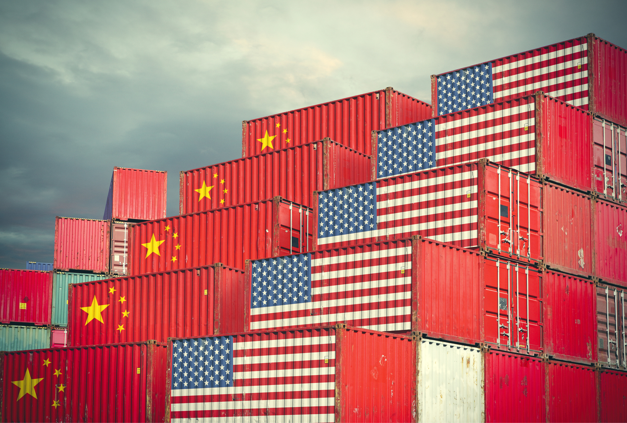 Cargo containers marked wth US and China flags, stacked side by side