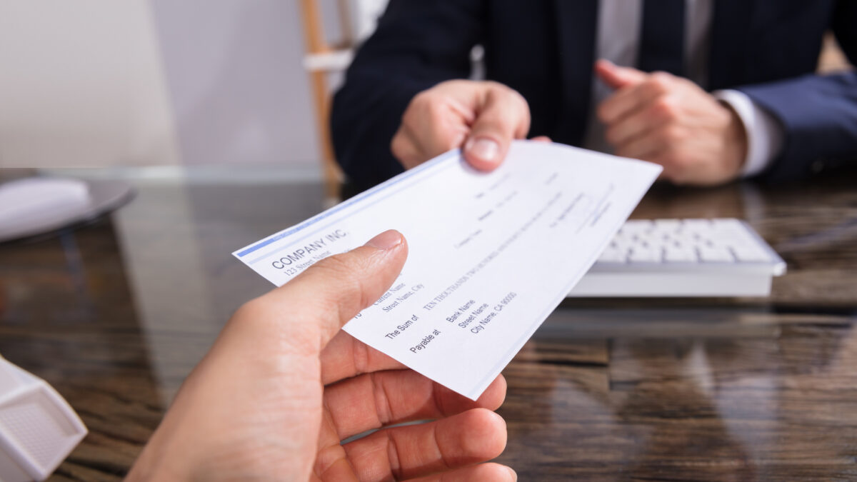 A person haning a cheque to a property agent
