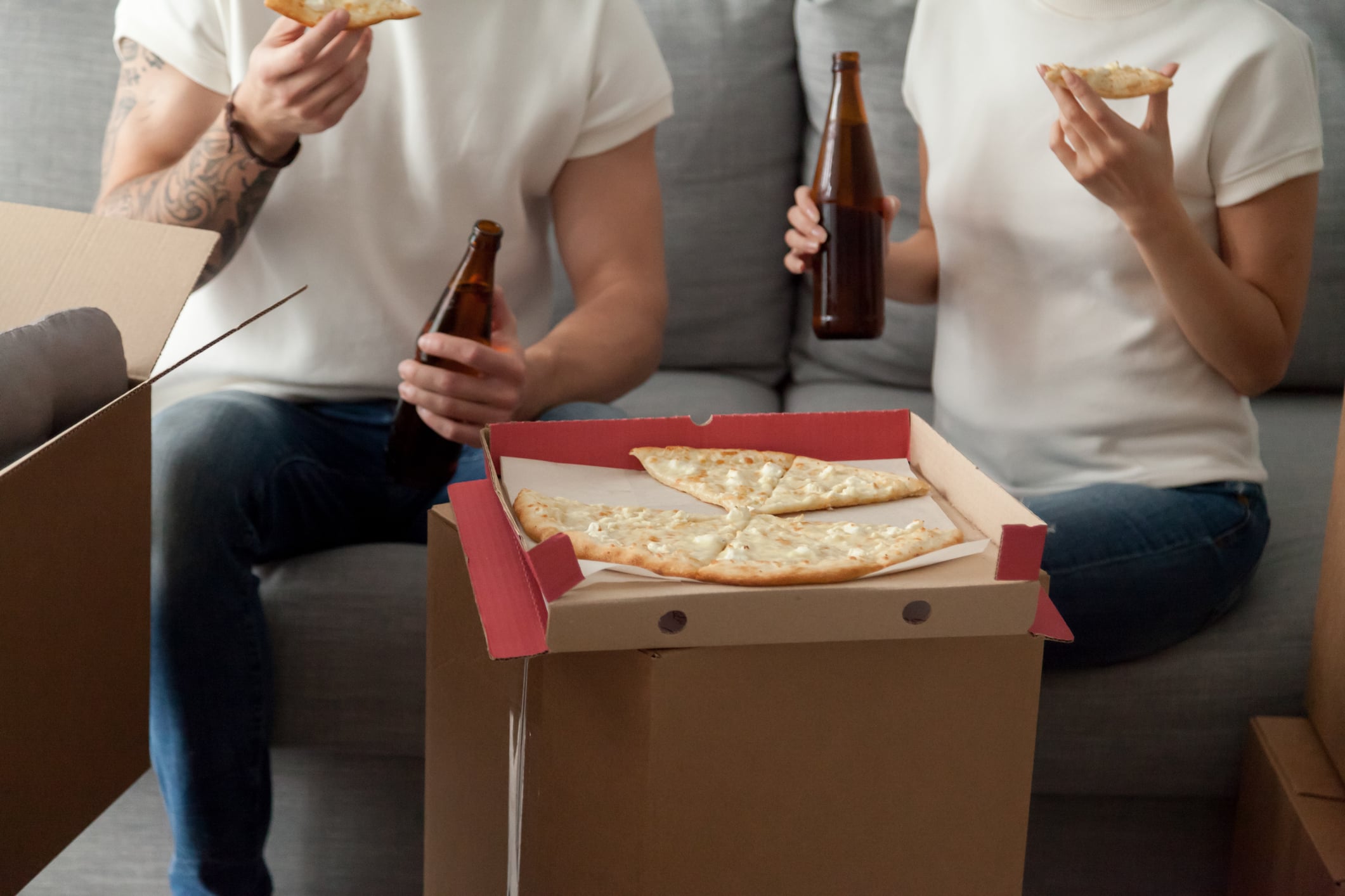 Student tenants eating pizza on a box