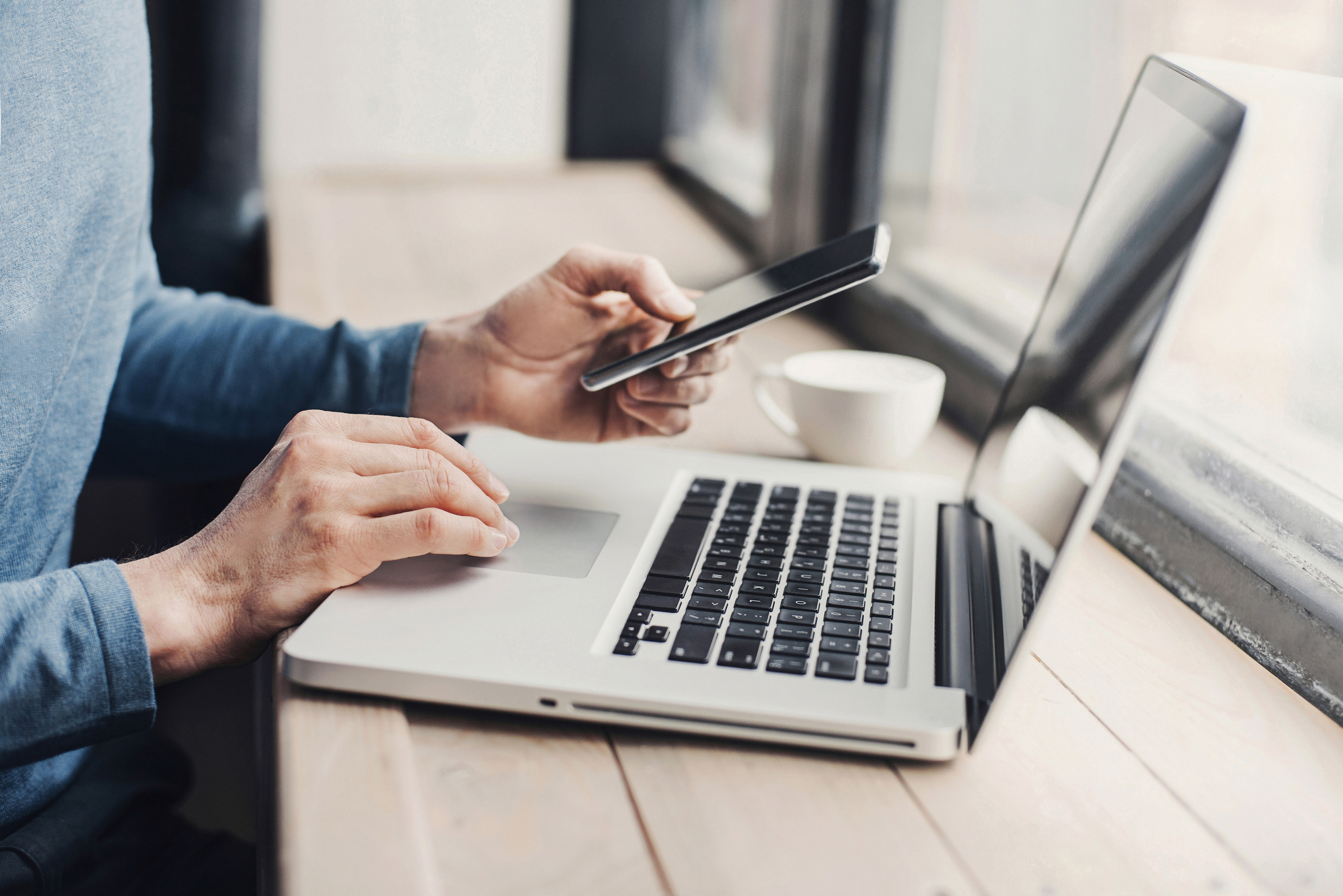 Man using laptop and smartphone