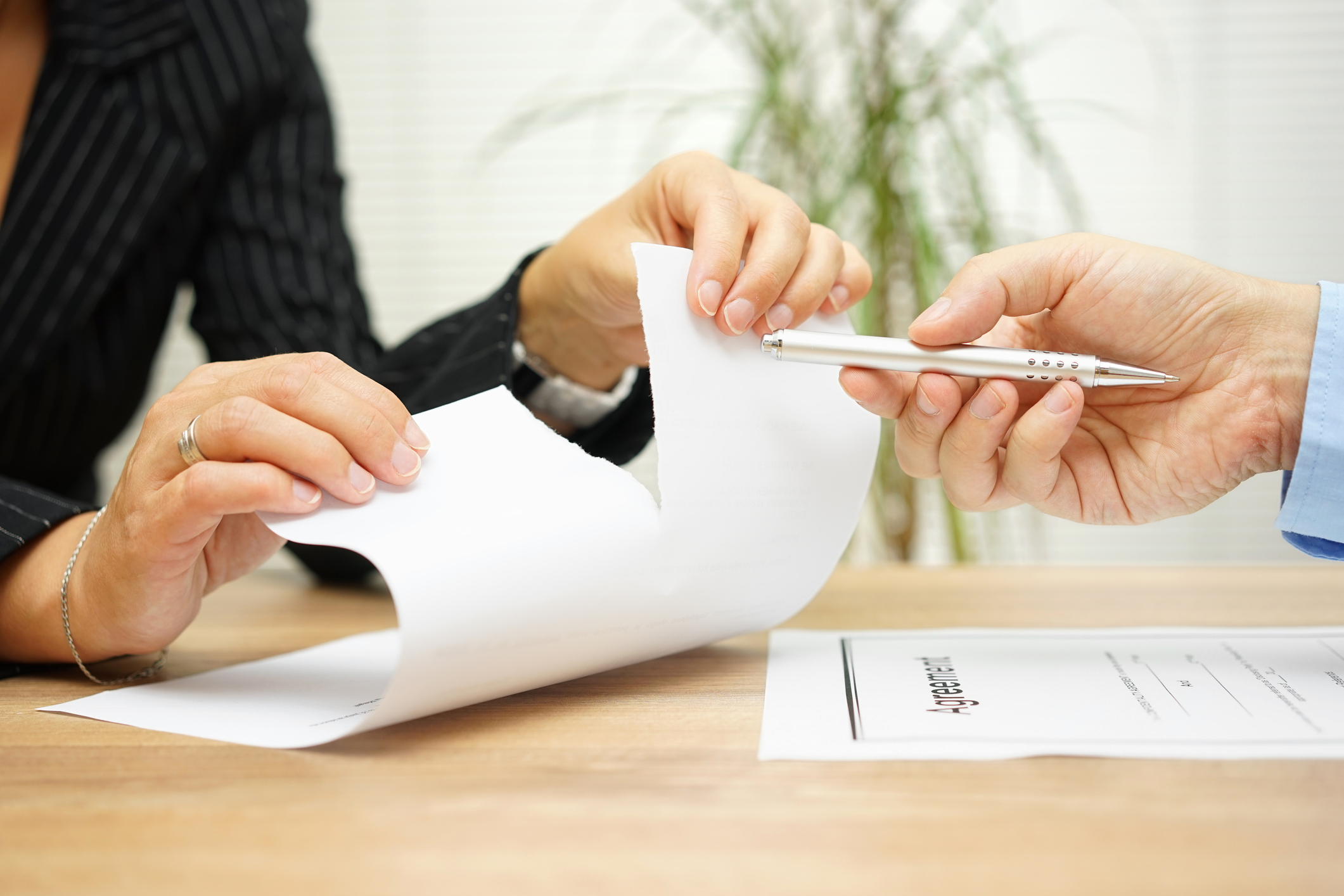 Person tearing contract