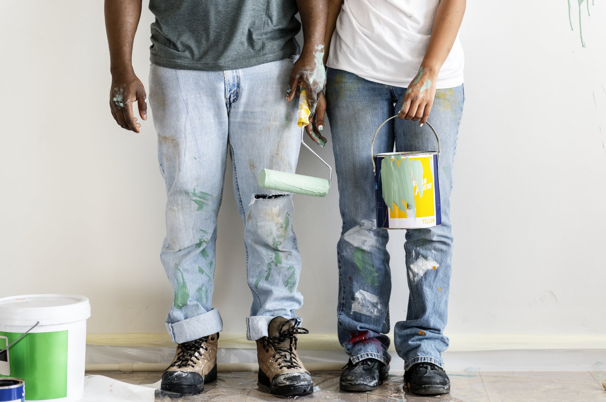 Two people painting a house
