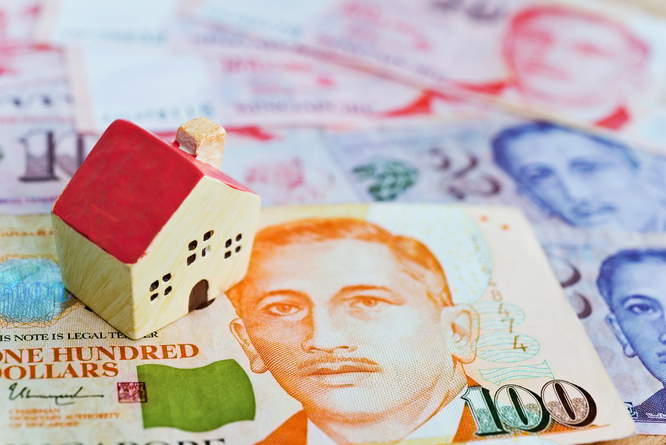 Model house on top of dollar notes