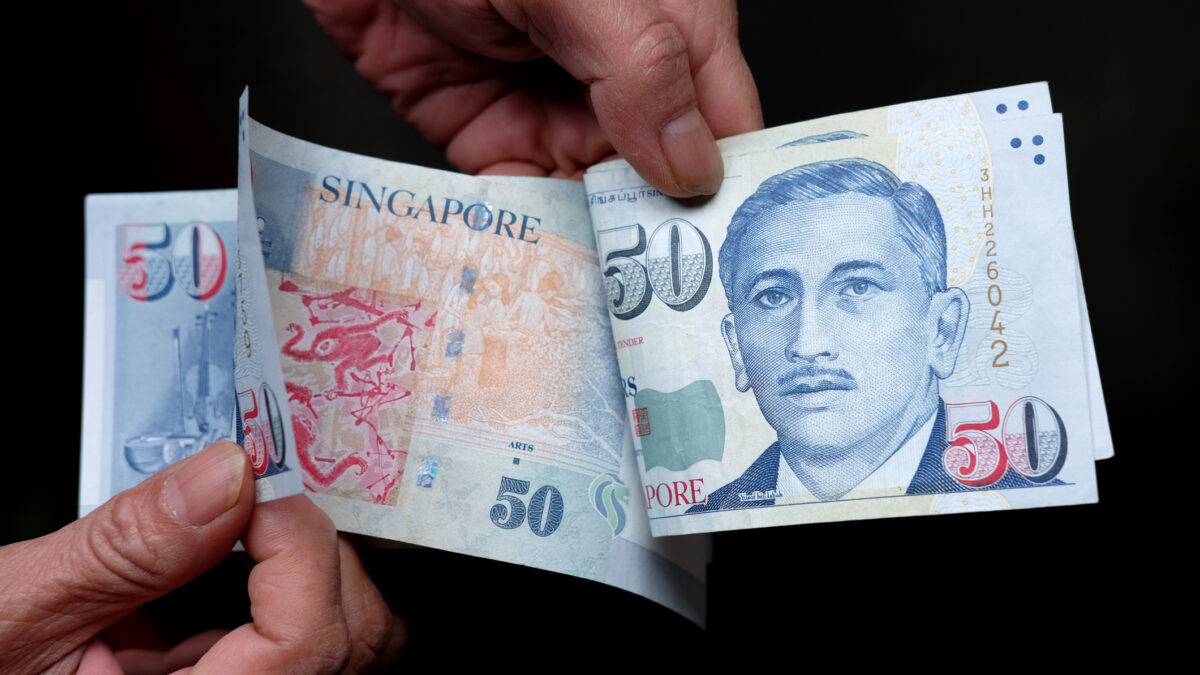 Someone counting out $50 notes