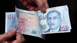 Someone counting out $50 notes
