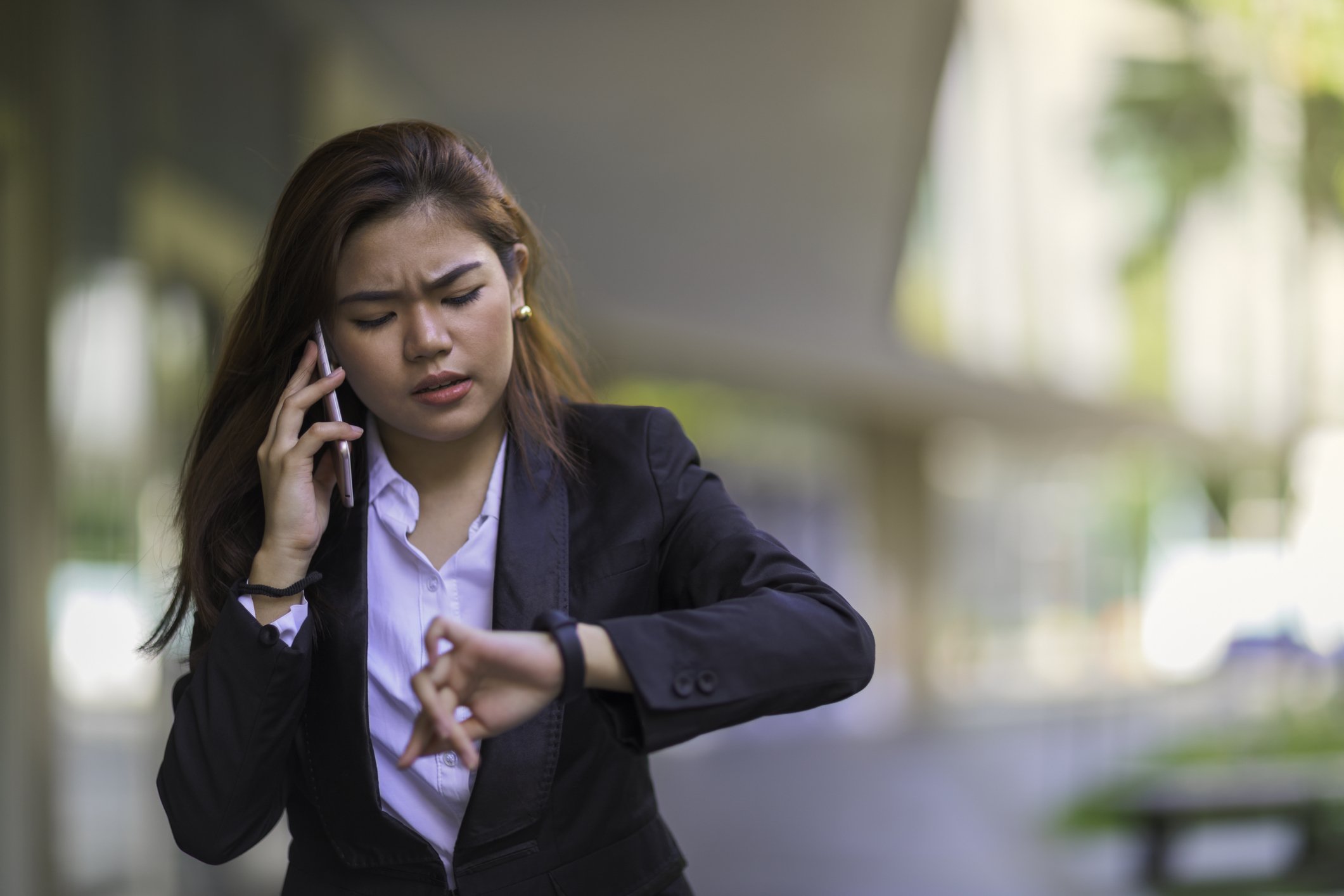 Lady on the phone and checking her watch