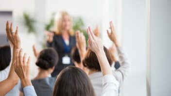 Group of people raising hands