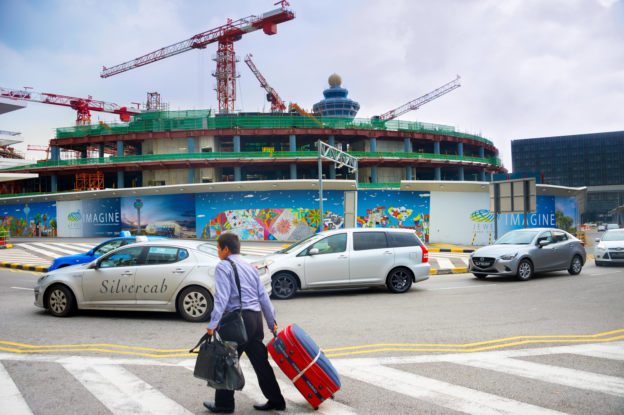 Man pulling luggage on Singapore road