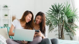 Friends looking online for suitable apartments to rent
