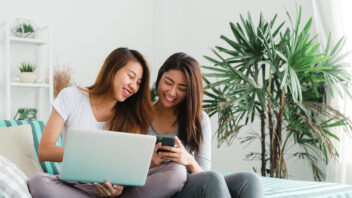 Friends looking online for suitable apartments to rent