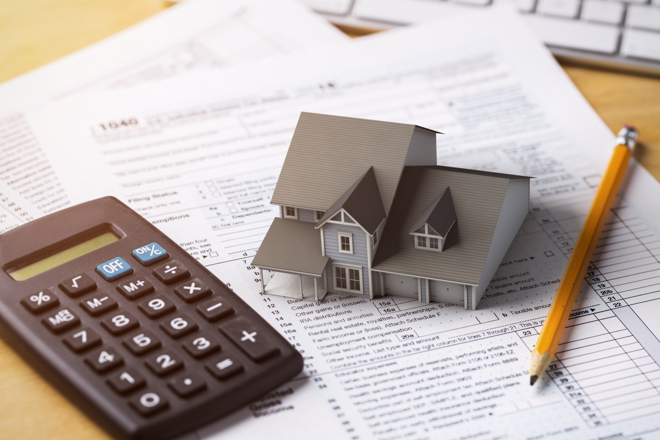 Miniature house on top of loan documents