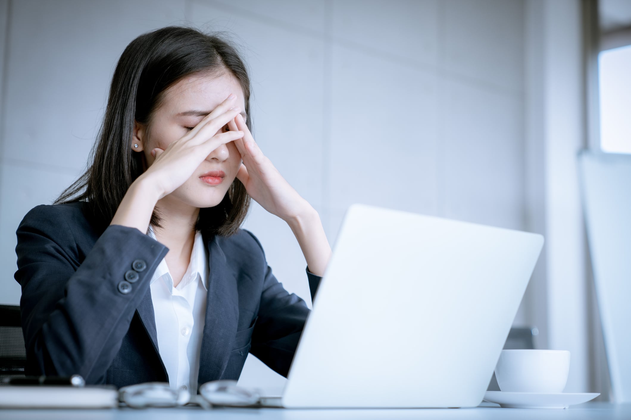 Anxious woman in front of laptop