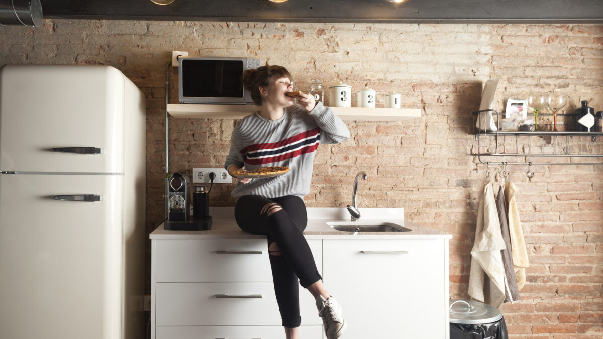 Happy student in her rented apartment