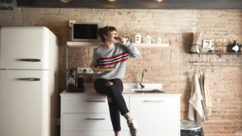 Happy student in her rented apartment
