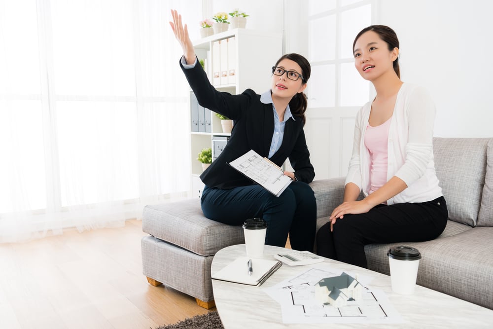 property agent showing her client the house 