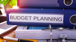 A stack of folders for budget planning