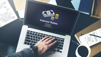 Man searching for interest rates on his laptop
